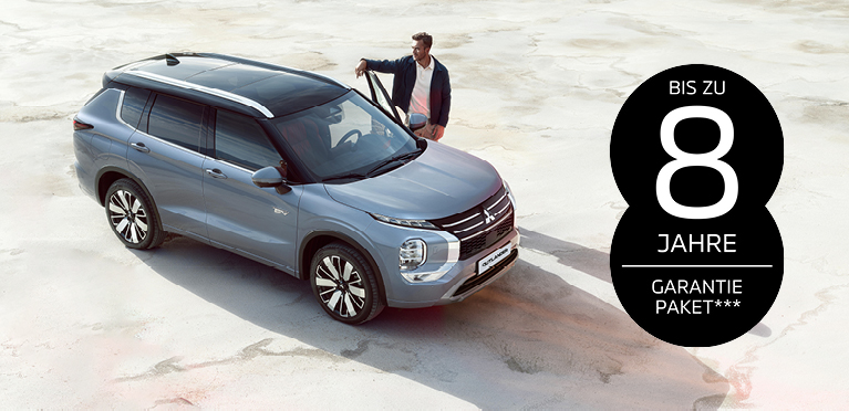 Mitsubishi Garantiepaket Mann steht neben dem Outlander mit Garantielogo im Bild